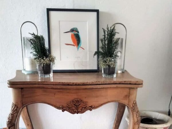 A wooden console table featuring a Common kingfisher print, perfect as wall art or an art print from Portugal Shop.