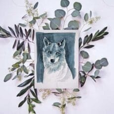 A Wolf Print of a watercolor painting of a wolf with eucalyptus leaves.