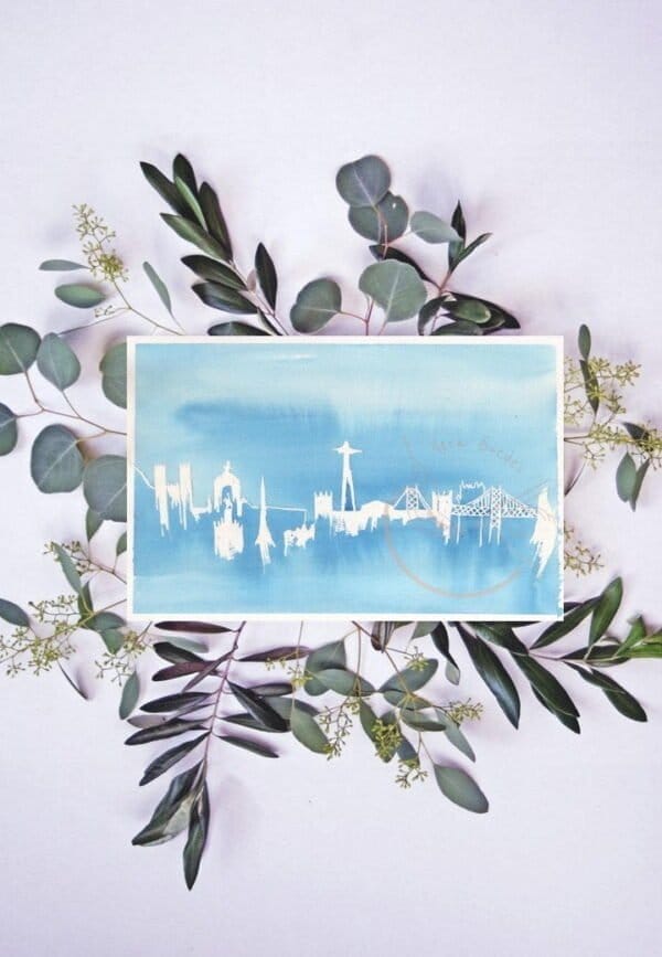 A Lisbon print depicting a blue card adorned with eucalyptus leaves, perfect for wall art.