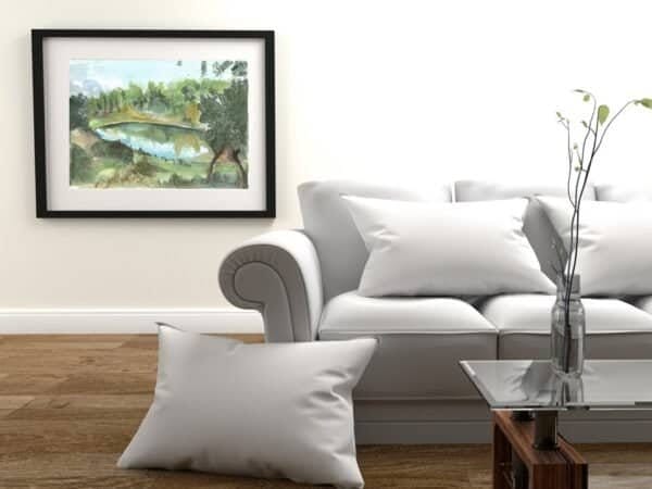A white couch in a living room with a Water dam Print on the wall.