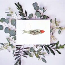 A card with an illustration of a Lisbon Sardine Print and eucalyptus leaves.