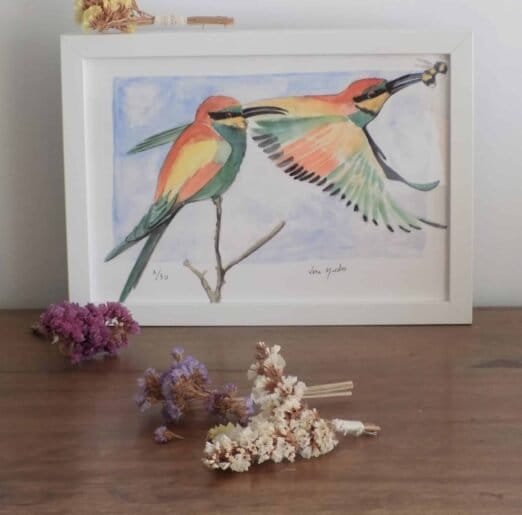 Two European Bee-Eaters in flight on a wooden table, available as an art print from Portugal Shop.