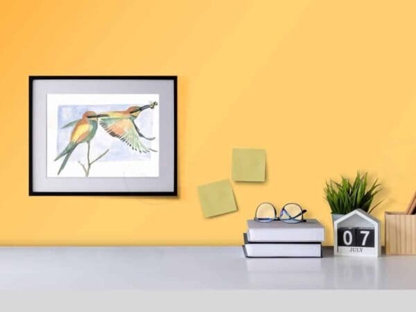 A European Bee-Eaters print of a watercolor painting of a bird on a desk.