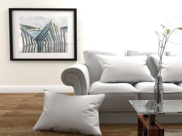 A fine White striped beach tents print of a white couch in a living room, perfect as wall art.