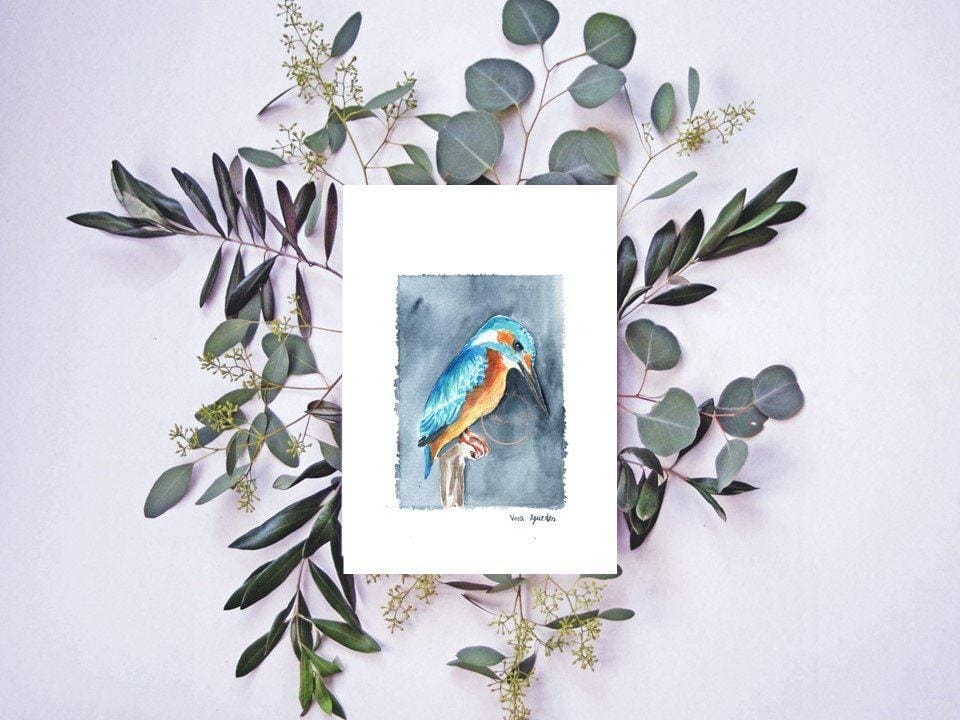 A fine art Kingfisher print with eucalyptus leaves.
