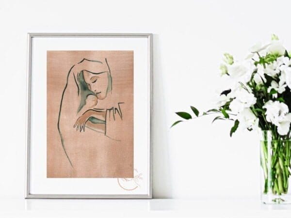 A framed Our Lady Love Print of a woman holding a baby.