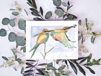 A watercolor painting of a bird with eucalyptus leaves, available as European Bee-Eaters Print.